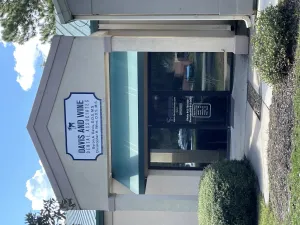 Entrance of the Davis and Wine dental office with a branded sign on the glass door.
